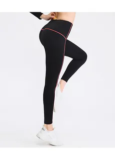Detailed side view of high waist black yoga leggings with pink side stripe and pocket.