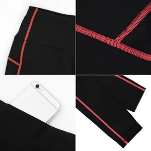 Macro detail of fleece lined yoga pants showing red flatlock seams and side phone pocket