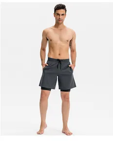 Full length view of men's quick-dry double-layered grey athletic shorts on fitness model