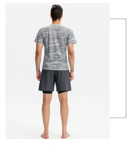 Back view of a man wearing grey camouflage sports t-shirt and 2-in-1 athletic running shorts