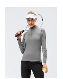 Detailed view of women's gray quarter-zip long sleeve athletic top for tennis training