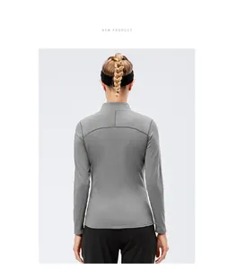 Back view of women's slim fit sports long-sleeve athletic top with stand collar design.