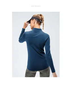 Back view of women's fleece-lined sports long sleeve top with high neck in navy blue