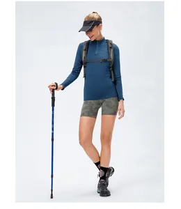 Women's fleece sports long sleeve top with zip neck for hiking or fitness training.
