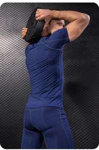 Achteraanzicht van een man in een marineblauw compressie fitnesspak die een gewicht optilt