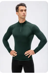 Close-up of men's dark green slim-fit compression shirt with half-zip collar detail.