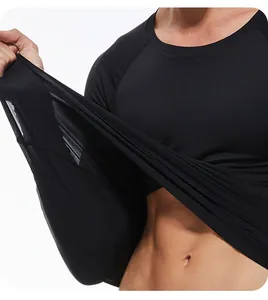 Close-up of men's black compression shirt demonstrating high fabric elasticity and stretch