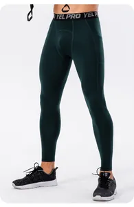 Detailed view of men's dark green compression pants with waistband text and side pocket