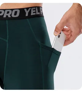 Close-up view showing the functional side pocket on men's dark green fitness leggings
