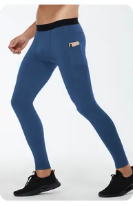 Detail of men's blue compression leggings featuring a functional side phone pocket