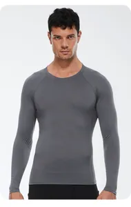 Front view detail of a grey long-sleeved men's compression sports top.