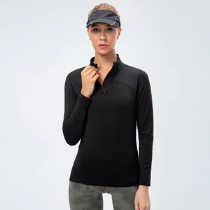 Women's slim fit black long sleeve athletic top with half-zip stand collar for yoga