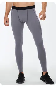 Macro view of grey men's high-elastic compression leggings with side phone pocket