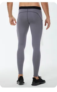 Back view of professional men's thermal high elastic sports compression leggings in grey color.