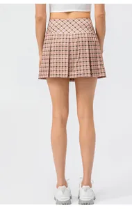 Back view of a high-waisted pink plaid pleated tennis skirt for women sports and running