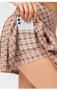 Close-up detail of a functional side pocket on pink plaid sports skort for holding a phone