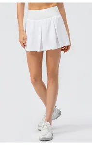 Detailed view of women's white high-waisted pleated tennis skort for sports and fitness