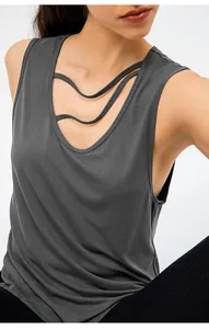 Detail shot of grey yoga tank top featuring unique strappy neckline design