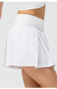 Macro view of white pleated sports skort showing high waist design and lightweight fabric texture