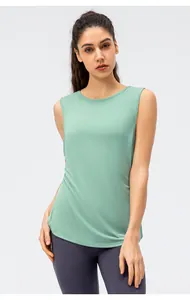 Front view of a women's breathable mint green loose yoga tank top with sleeveless design