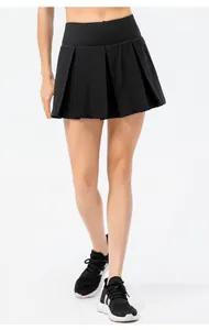 Detailed view of women's black pleated athletic skort for tennis, running and yoga