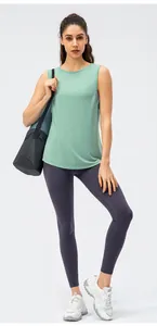 Close-up of a mint green loose yoga tank top and dark grey high-waisted leggings set