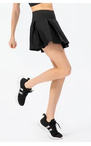 Close-up dynamic view of a black pleated tennis skirt with built-in shorts for running.