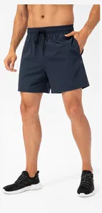 Detail of navy blue quick-dry sports shorts with elastic drawstring waist for men.