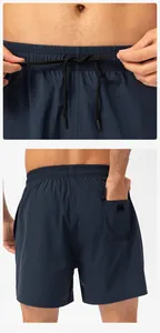 Close-up detail of navy quick-dry athletic shorts showing drawstring waist and back pocket