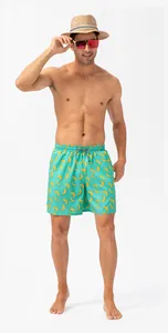Full view of men's banana print swim trunks on a model, showcasing summer beach style