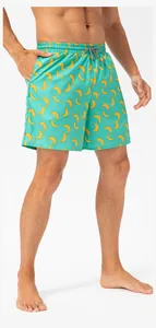 Detail of men's quick-dry turquoise swim trunks with vibrant banana print and drawstring
