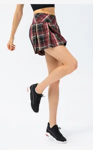 Side view detail of women's red plaid pleated sports skirt with anti-exposure design.