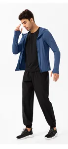 Full body view of a male model wearing a blue UPF 50+ sun protection jacket and joggers