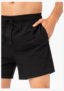 Detail view of men's black quick-dry sport shorts showing the elastic waistband and pocket.
