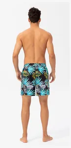 Back view of men's quick-dry beach shorts featuring a vibrant tropical leaf print.