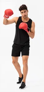 Model wearing breathable quick-dry men's loose black sports shorts for boxing and fitness training