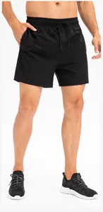 Detail of men's black quick-dry athletic shorts with drawstring and elastic waist.