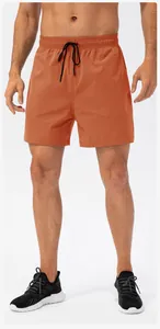Front view of orange men's quick-dry sports shorts featuring an elastic drawstring waist