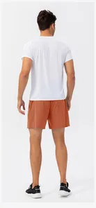 Back view of men's quick-dry sports shorts in orange with a white athletic shirt