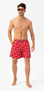 Close-up detail of men's quick-dry red swimming shorts with white crab pattern