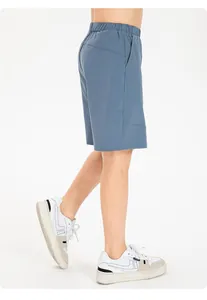 Side view detail of children's blue quick-dry breathable loose athletic shorts
