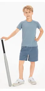 Child model in blue quick-dry athletic t-shirt and shorts set holding baseball bat