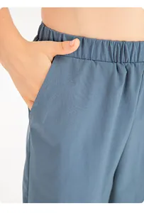Close-up detail showing the pocket and waistband on blue quick-dry kids' sports shorts.