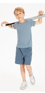 Full view of boy in quick-dry breathable blue sports shorts and matching t-shirt