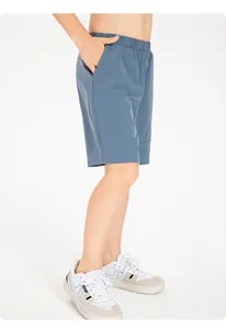 Side profile detail of kids loose blue quick-dry nylon sports shorts for basketball.