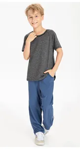 Boys loose quick-dry athletic pants paired with a grey t-shirt for running and sports.
