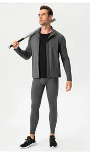Full body view of men's grey compression sports suit with jacket and leggings in studio