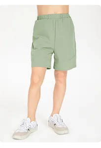 Detailed view of kids' sage green quick-dry breathable sports shorts with elastic waistband.