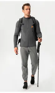 Full body view of a man wearing grey slim fit outdoor sports thermal jacket and pants