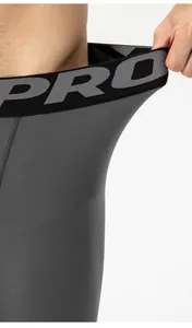 Close-up detail showing the high-elastic waistband of men's thermal compression leggings